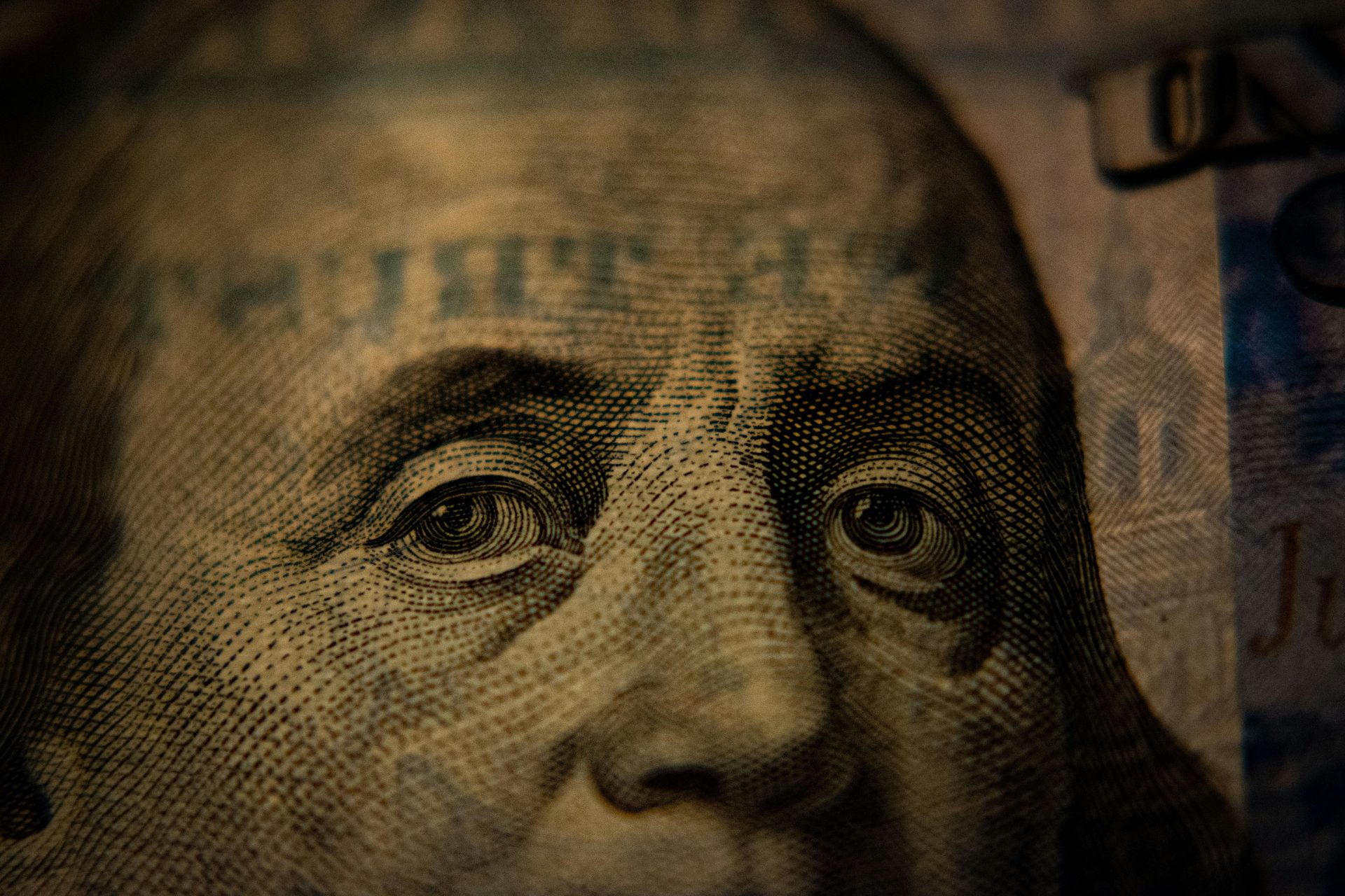 Close-up of Ben Franklin's eyes and top half of his head from the hundred dollar bill