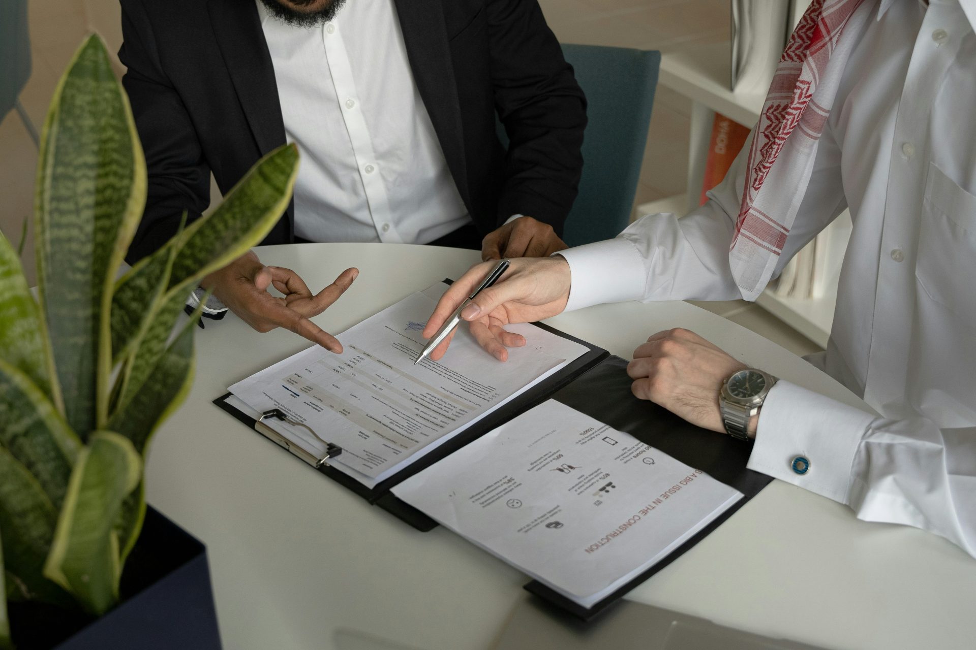 2 men discussing a document together