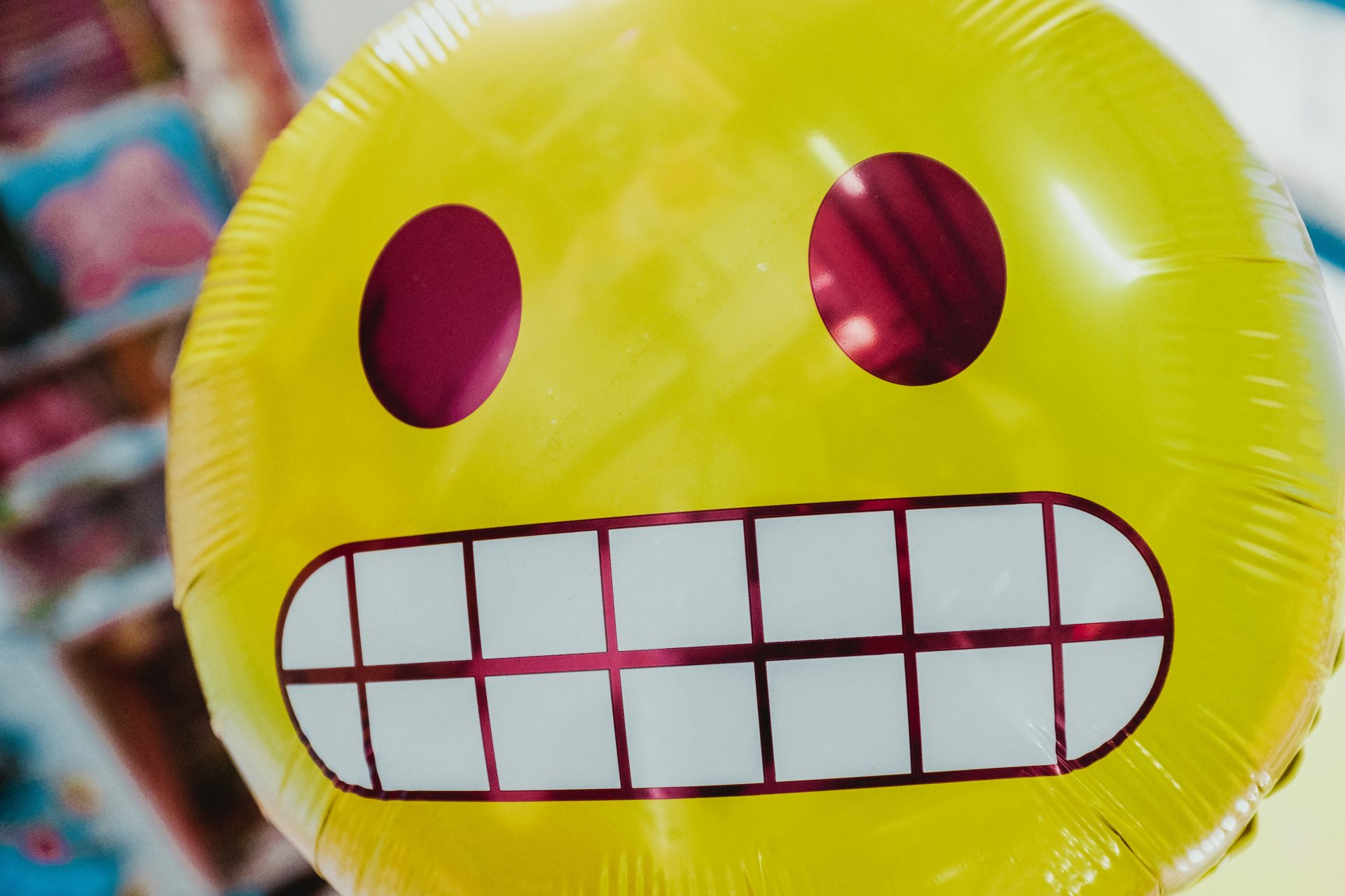 Close-up of a yellow balloon face grimacing awkwardly.
