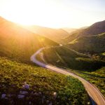 mountain pass with road going into the distance at sunrise