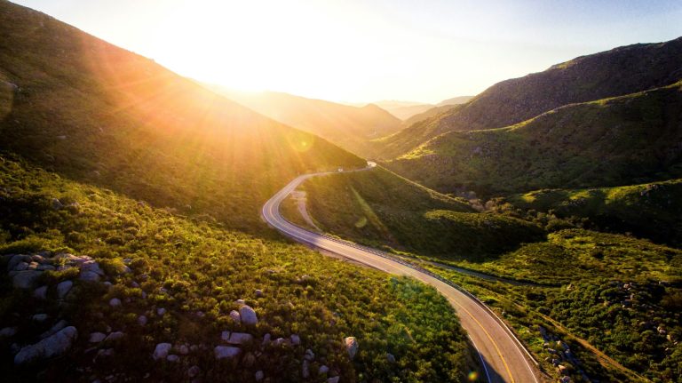 mountain pass with road going into the distance at sunrise