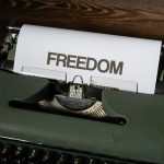 Typewriter with FREEDOM written in large type.