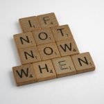 Scrabble tiles spelling "If Not Now When" in vertical rows