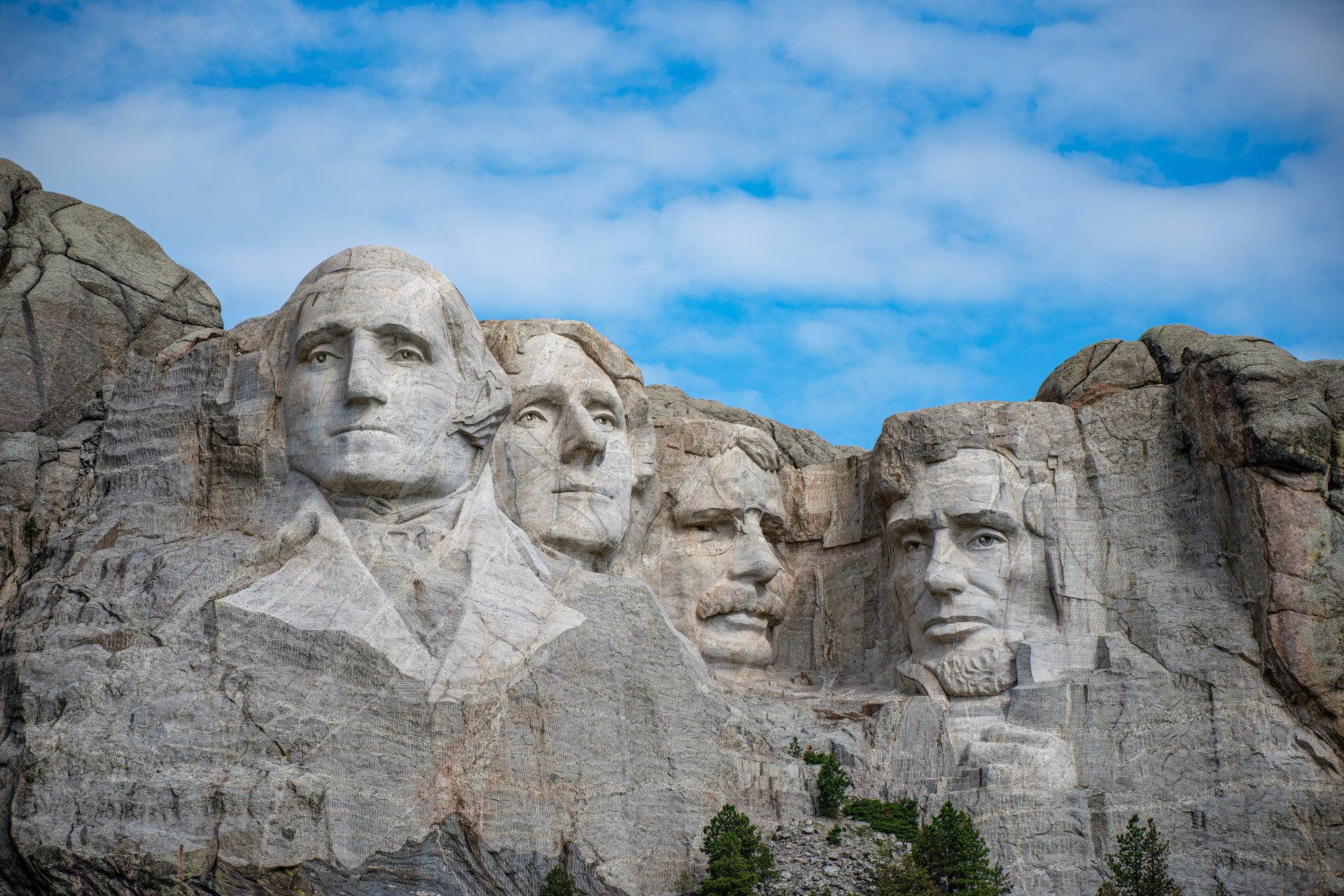 Mount Rushmore - Presidents Washington, Jefferson, (T) Roosevelt, and Lincoln with a clear blue sky.