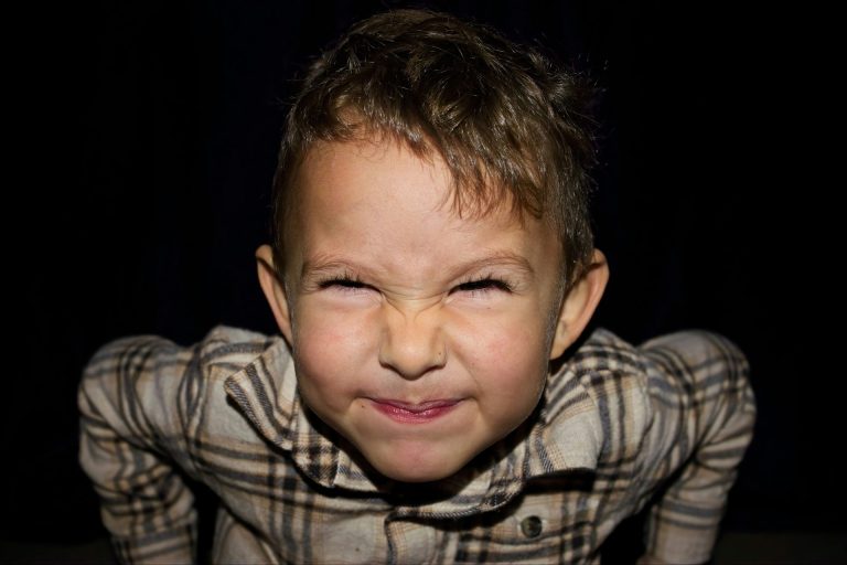 Picture of a young boy with his face scrunched up in a grimace
