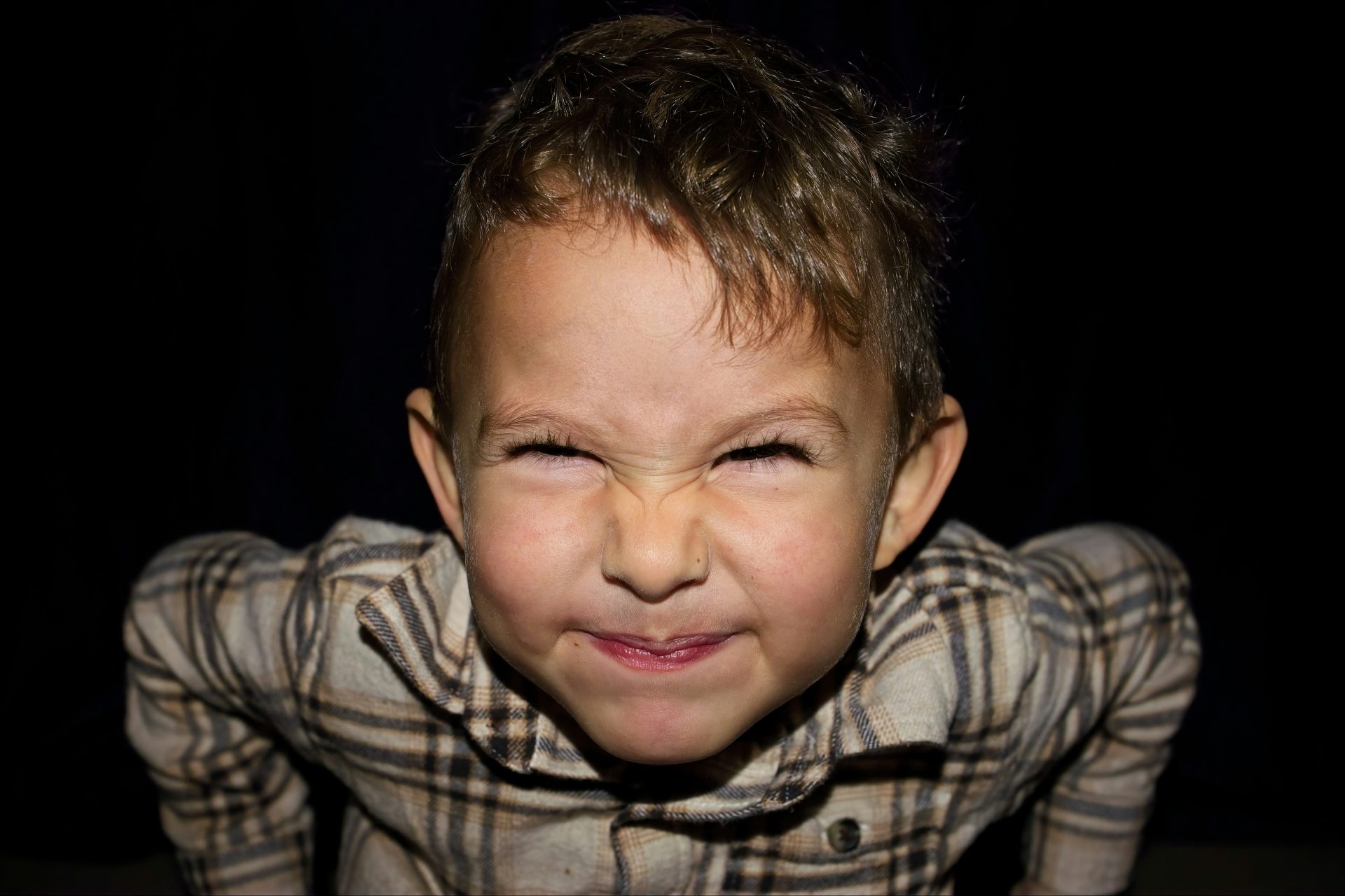 Picture of a young boy with his face scrunched up in a grimace